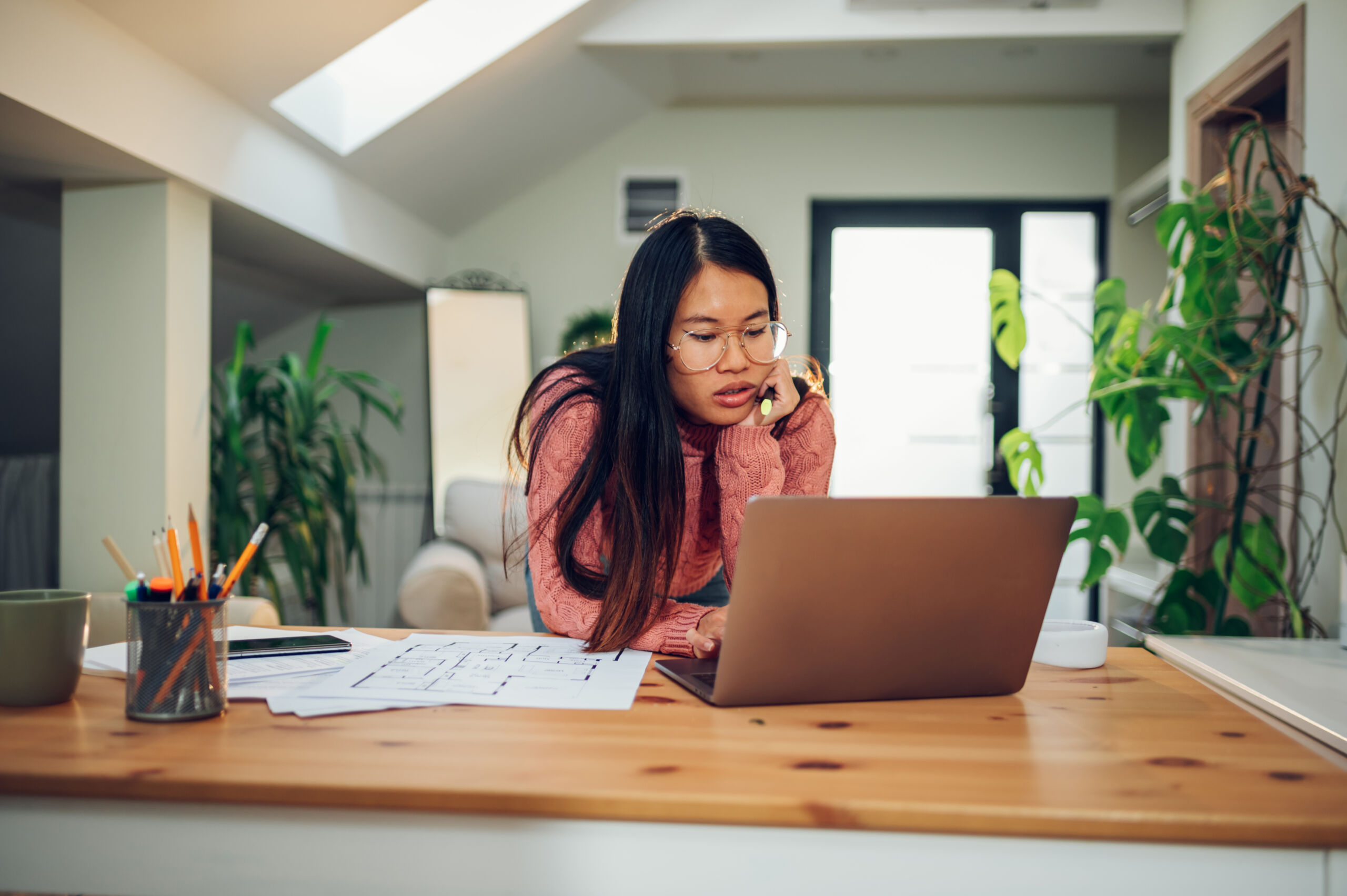 vietnamese asian woman using a laptop in her home